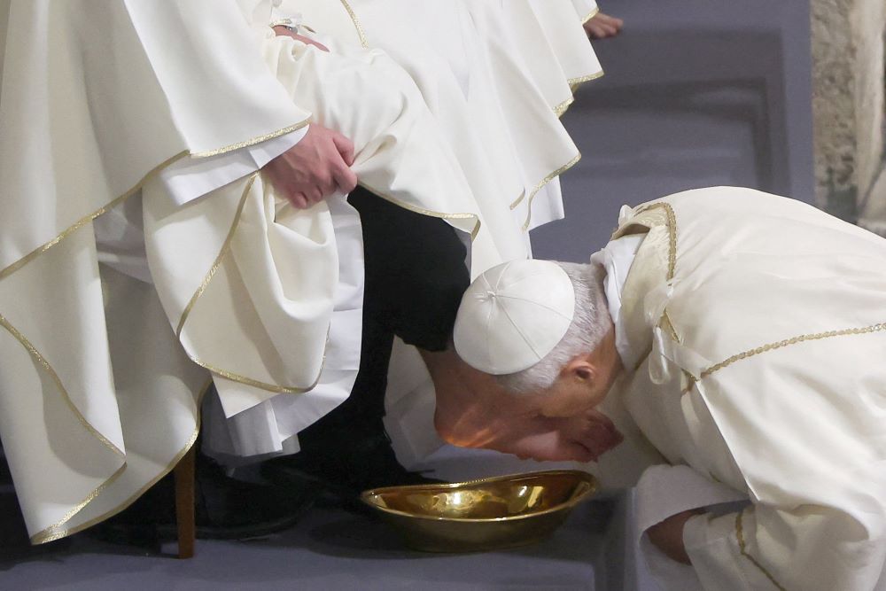 Pope Leo XIV kisses the foot of a clergyman after washing it as he celebrates the Holy Thursday Mass of the Lord's Supper in the Basilica of St. John Lateran at Vatican April 2, 2026. (OSV News/Reuters/Vincenzo Livieri)