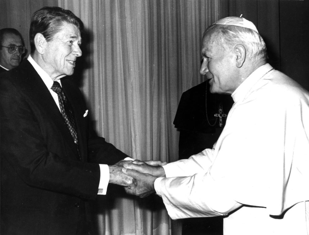 President Ronald Reagan shakes hands with Pope John Paul II during Reagan's June 6, 1982, visit to the Vatican. The two worked together during the Cold War to fight the influence of the Soviet Union. (CNS/Reuters)