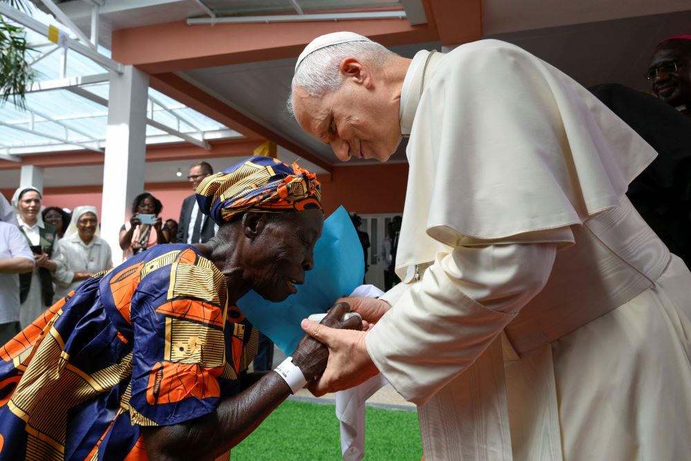 Pope Leo XIV greets an elderly woman during his visit to a nursing home in Saurimo, Angola, on April 20, 2026. (OSV News/Vatican Media/Simone Risoluti)