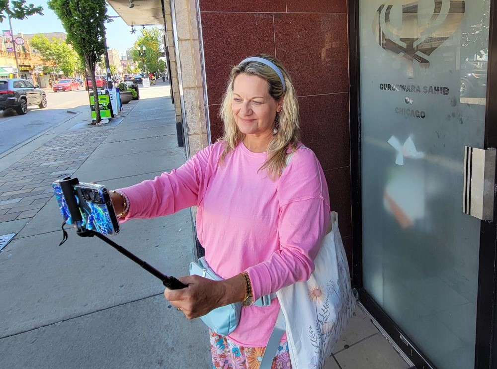 Rev. Vicki Garlock takes a selfie outside Devon Gurdwara Sahib of Chicago, a Sikh religious site, during her trip to obtain the Guinness World Record for most places of worship visited in one month, September 2025. The Gurdwara was one of 185 places of worship she visited. (Courtesy of Vicki Garlock)
