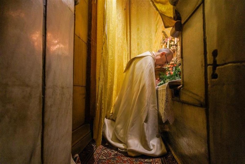 Cardinal Pierbattista Pizzaballa prays at the Holy Sepulchre, the tomb where Christ's body was laid after his crucifixion and before the resurrection, as he celebrated Mass of the Lord's Supper in the Church of the Holy Sepulcher April 2 in Jerusalem. (OSV News/Courtesy Latin Patriarchate of Jerusalem)