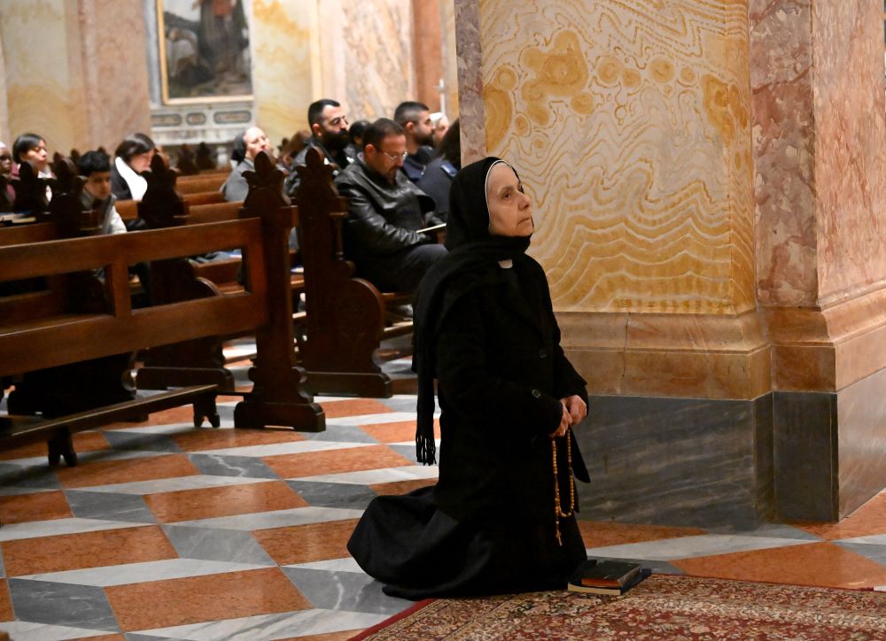A nun prays before the Good Friday service in St. Saviour Monastery in the Old City of Jerusalem, April 3. Israeli security forces stopped Christians from reaching the Via Dolorosa, while allowing Muslims and Jews passage to the area. Border police said the safety precautions were because of the U.S.-Israeli war with Iran. (OSV News/Debbie Hill)