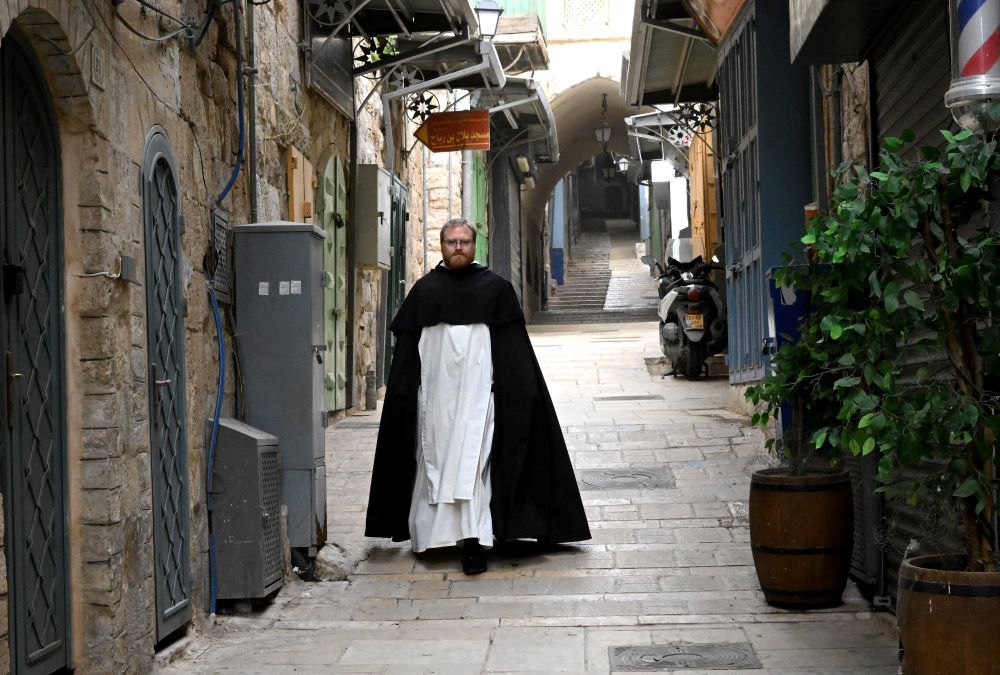 A priest walks on the Via Dolorosa on Good Friday, in the Old City of Jerusalem, April 3, 2026. Israeli security forces stopped Christians from reaching the Via Dolorosa, while allowing Muslims and Jews passage to the area. Border police said the safety precautions were because of the U.S.-Israeli war with Iran. (OSV News/Debbie Hill)