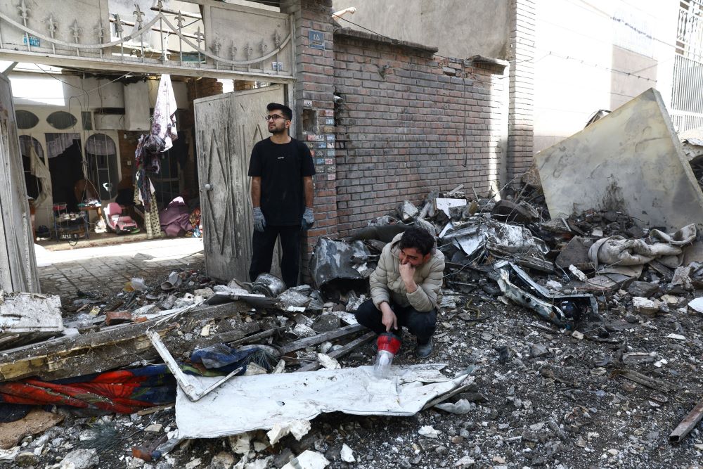 People react at the site of a residential building in Tehran, Iran, March 27, that was damaged by a strike amid the U.S.-Israeli war with Iran. (OSV News/Reuters/West Asia News Agency/Majid Asgaripour)
