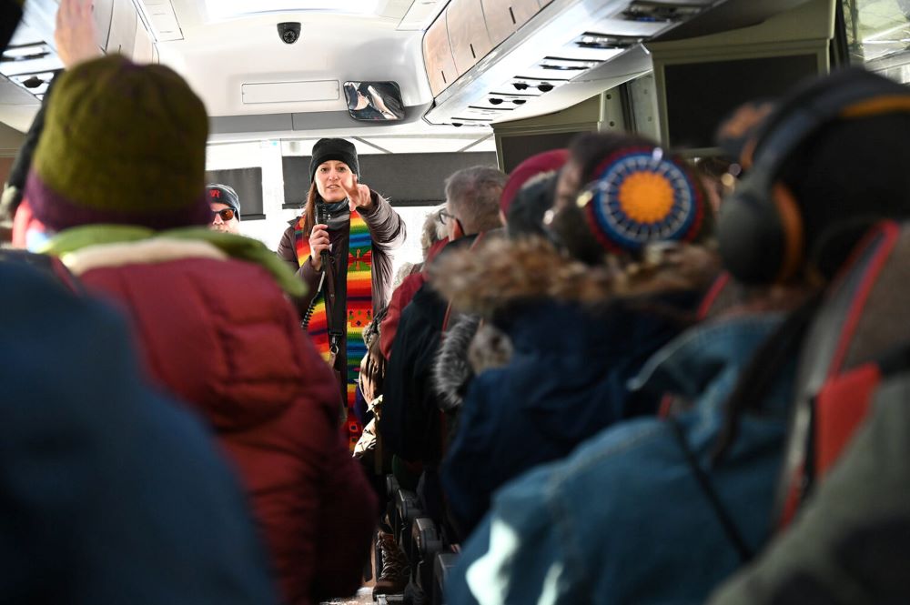 The Rev. Susie Hayward speaks to clergy on a bus as they move out to observe and document the actions of immigration enforcement agents, Thursday, Jan 22, 2026, in Minneapolis. (RNS/Jack Jenkins)