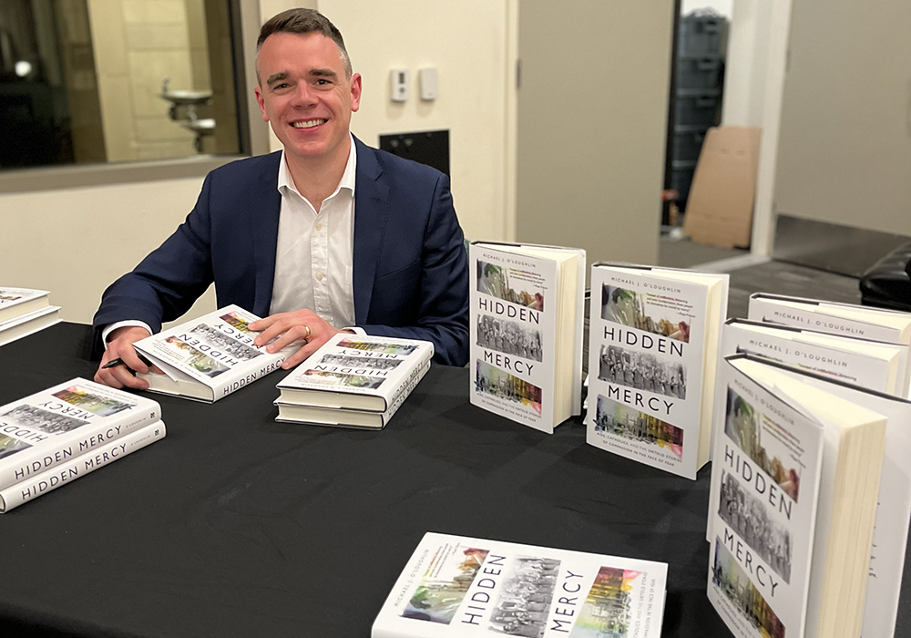 Michael J. O'Loughlin is pictured during a 2022 book-signing event for his book "Hidden Mercy: AIDS, Catholics, and the Untold Stories of Compassion in the Face of Fear." (Courtesy of Michael J. O'Loughlin)
