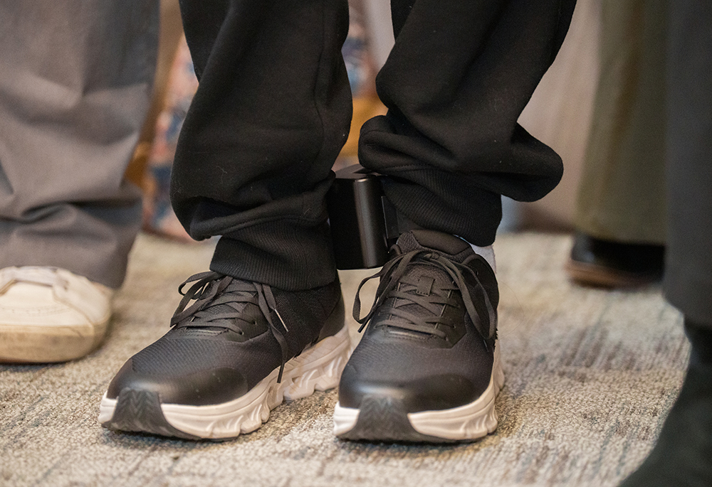 Dylan Lopez Contreras wears an ankle monitor during a press conference to welcome him home after being freed from ICE detention, March 19, 2026 in New York. Catholics in Harrisburg, Pennsylvania, are wearing faux ankle monitors in solidarity with migrants. (AP photo/Adam Gray)