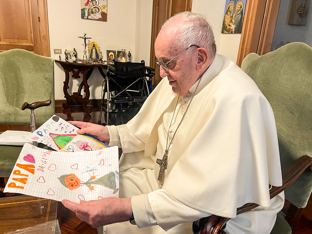Pope Francis receives drawings from the children of Vatican News journalist Salvatore Cernuzio at Casa Santa Marta, Vatican City, June 2022. (Courtesy of Salvatore Cernuzio)