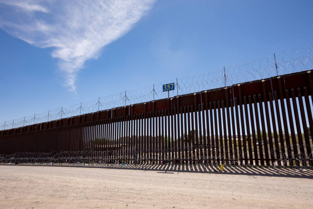 The border wall stretches along a dirt road near Sunland Park, N.M. (Gaby Velasquez/Puente News Collaborative)