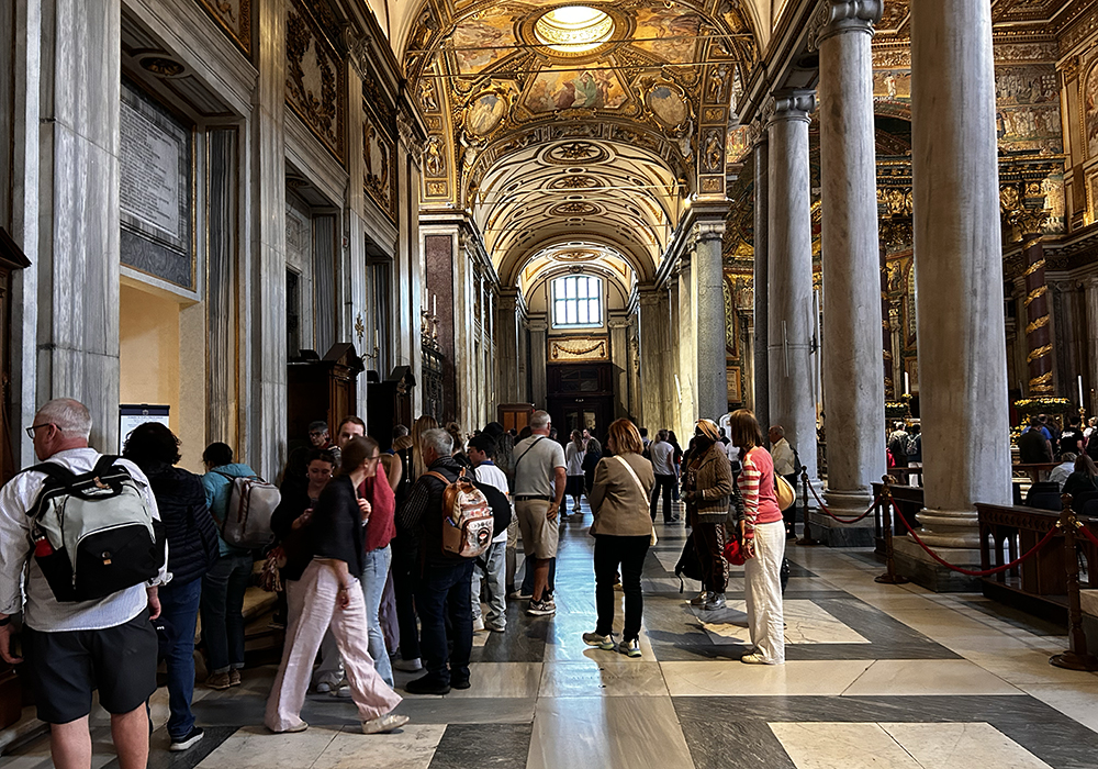 Pilgrims gather around the tomb of Pope Francis along the side of the Basilica of St. Mary Major in Rome. (NCR photo/Justin McLellan)