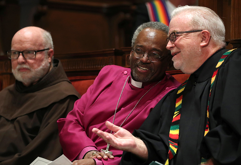 Franciscan Fr. Richard Rohr, Bishop Michael Curry, then-presiding bishop of the Episcopal Church, and the Rev. Jim Wallis, then-president of Sojourners, chat before leading an interfaith vigil titled "Reclaiming the Integrity of Faith During Political and Moral Crisis" May 24, 2018, in Washington. (CNS/Reuters/Jonathan Ernst) 