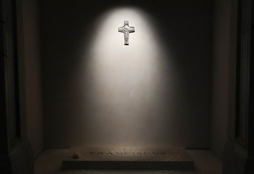 A light shines on a replica of Pope Francis' pectoral cross above his tomb in the side aisle of Rome's Basilica of St. Mary Major early April 27, 2025. (CNS/Lola Gomez)