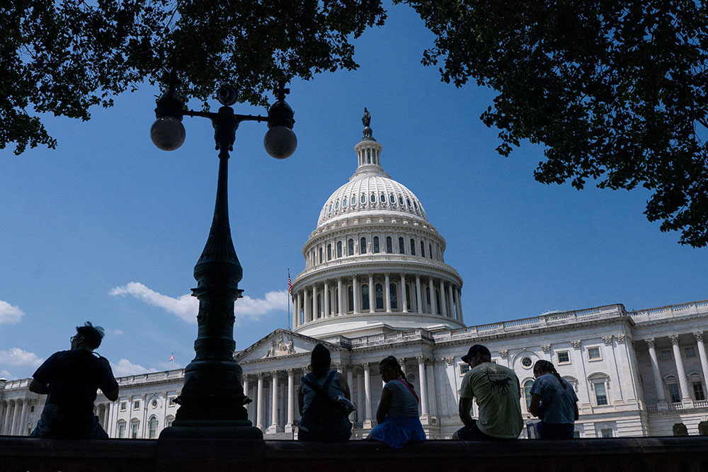 Visitors to the U.S. Capitol rest in the shade on Capitol Hill in Washington June 25, 2025. (OSV News/Reuters/Nathan Howard)