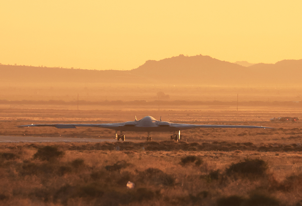 The U.S. Air Force's B-21 "Raider", the long-range stealth bomber that can be armed with nuclear weapons, rolls onto the runway at Northrop Grumman's site at Air Force Plant 42, during its first flight, in Palmdale, California, in this 2023 file photo. (OSV News/Reuters/David Swanson)