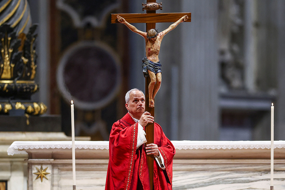 Pope Leo XIV holds a crucifix as he leads the Good Friday Liturgy of the Lord's Passion in St. Peter's Basilica at the Vatican April 3, 2026. (OSV News/Reuters/Guglielmo Mangiapane)