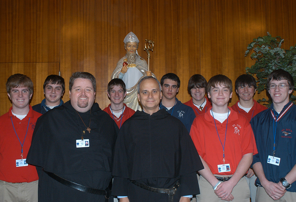 Then-Fr. Robert F. Prevost, now Pope Leo XIV, front center, prior general of the Augustinian order, poses with Augustinian Fr. Tom McCarty, president of St. Rita High School in Chicago, and upperclassmen in January 2006. (OSV News/Courtesy The Beverly Review)