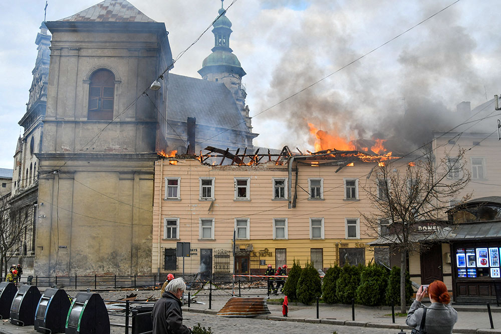 Firefighters work at the site of a residential building in Lviv, Ukraine, hit by a Russian drone strike March 24, 2026, amid Russia's massive nationwide attack on Ukraine that day. (OSV News/Reuters)