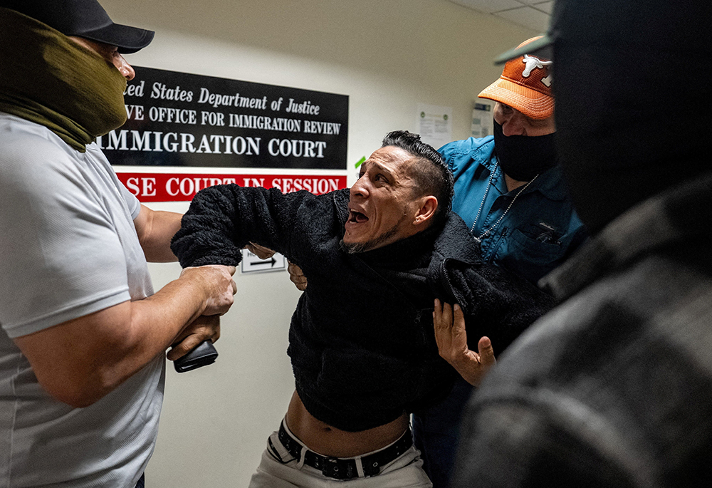 U.S. Immigration and Customs Enforcement agents and federal officers detain a migrant as he walks out from a hearing during targeted detainment at a U.S. immigration court in the Manhattan borough of New York City Oct. 27, 2025. (OSV News/Reuters/David 'Dee' Delgado)
