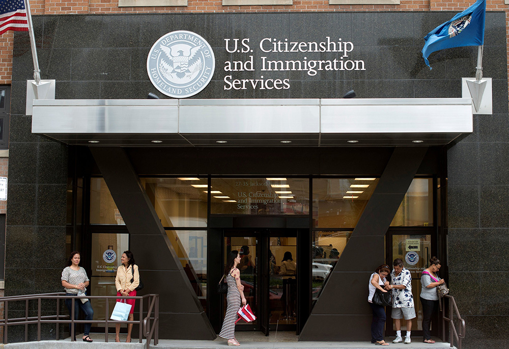People are pictured in a file photo standing on the steps of the U.S. Citizenship and Immigration Services office in New York City. (OSV News/Reuters/Keith Bedford)
