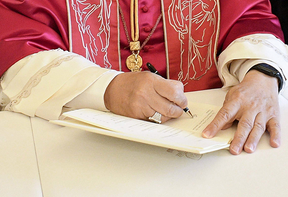 Pope Leo XIV signs his first apostolic exhortation, Dilexi Te ("I Have Loved You"), in the library of the Apostolic Palace at the Vatican Oct. 4, 2025, the feast of St. Francis of Assisi. His first encyclical, Magnifica Humanitas, will be published May 25, 2026, addressing artificial intelligence and the protection of human dignity, the Vatican announced May 18, 2026. (OSV News/Vatican Media/CPP)