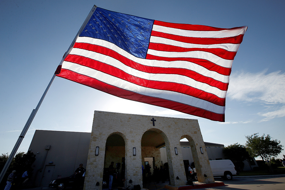 A file photo shows a U.S. flag outside Mary Immaculate Catholic Church in Dallas. Two-thirds of U.S. adults who regularly attend religious services have heard their clergy speak about at least one political or social issue recently, according to a new Pew Research Center survey. (OSV News/Reuters/Carlo Allegri)