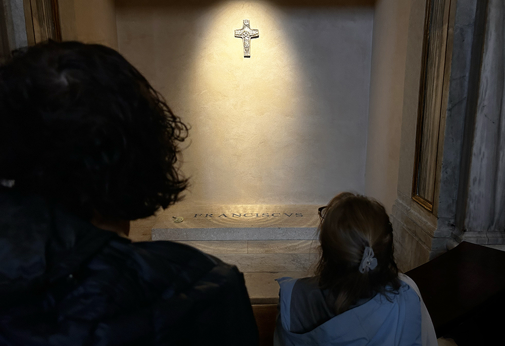 Pilgrims gather around the tomb of Pope Francis along the side of the Basilica of St. Mary Major in Rome. (NCR photo/Justin McLellan)