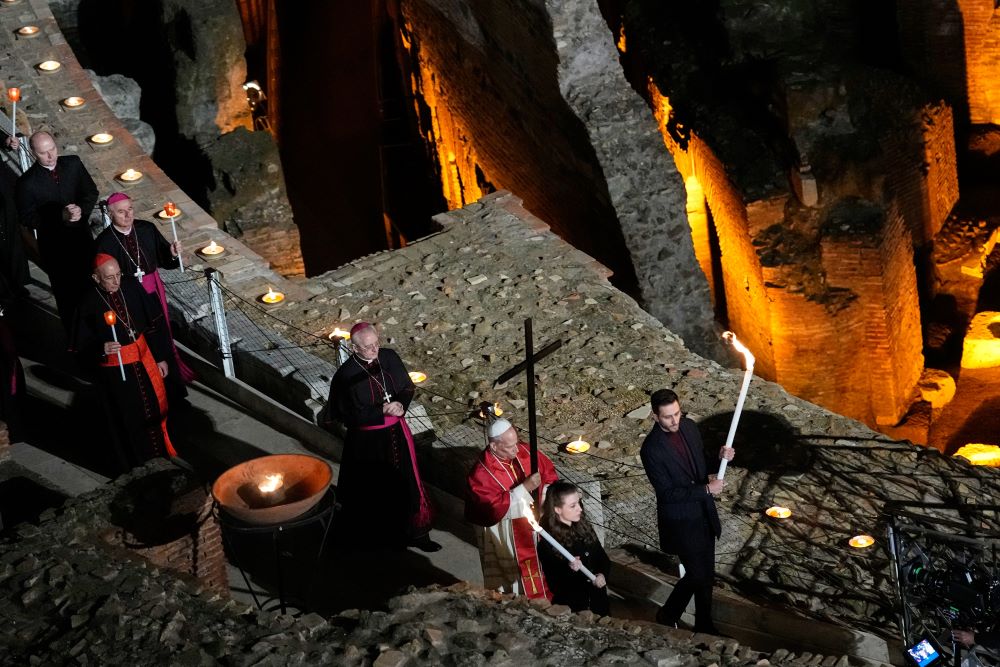 Pope Leo XIV carries a lightweight, 5-foot wooden cross during the Via Crucis, the torchlit Good Friday Stations of the Cross procession at the Colosseum in Rome April 3, 2026, which symbolically retraces Jesus Christ's steps to his crucifixion on Calvary in Jerusalem. (AP/Alessandra Tarantino, file)