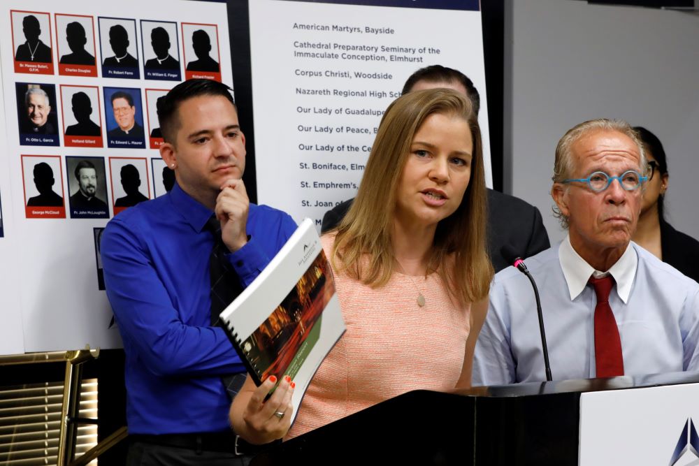 Joseph Caramanno, left, and attorney Jeff Anderson listen as Bridie Farrell addresses a news conference in New York Aug. 14, 2019. Caramanno accused Msgr. John Paddack of child sex abuse and sued the Archdiocese of New York in August 2019. (AP/Richard Drew)