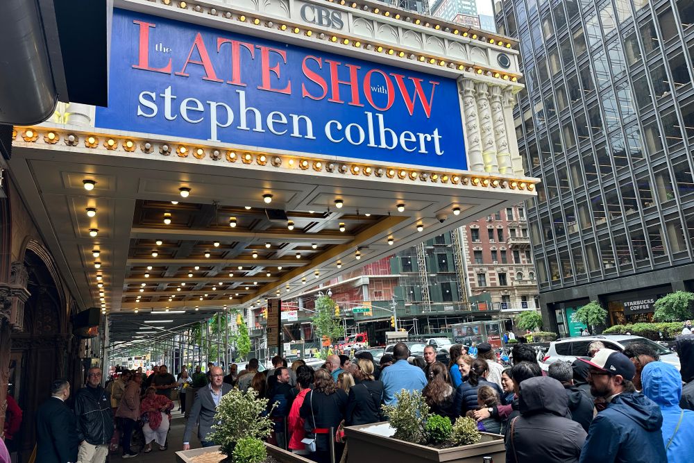 Fans line up in the rain outside the Ed Sullivan Theater in New York on May 21, 2026, ahead of the final episode of "The Late Show with Stephen Colbert." (AP/Ted Shaffrey)