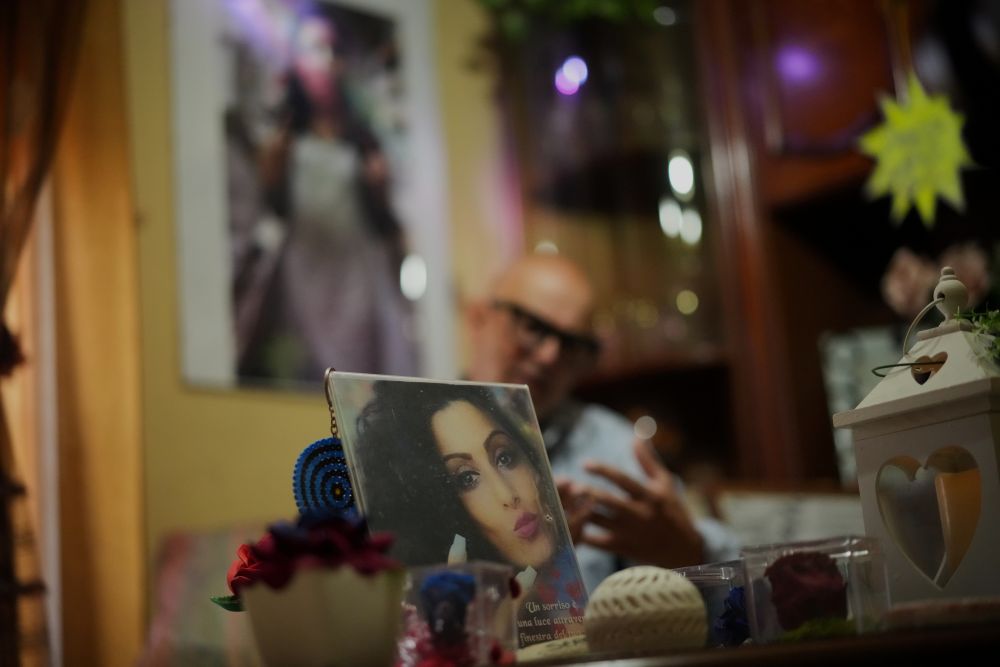 Angelo Venturato talks during an interview with the Associated Press next to photos of his daughter Maria, who died at of 25 of a cancer he claims to be connected to decades of pollution from illegal waste dumping and burning, much of it linked to organized criminal groups, in the southern town of Acerra, May 22, 2026. (AP/Andrew Medichini)