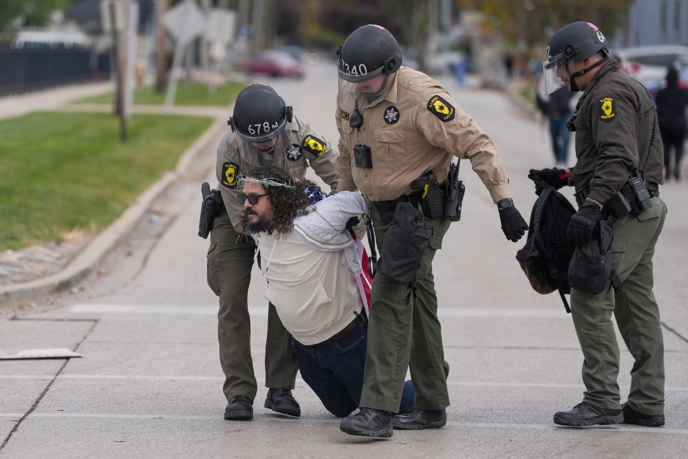 A demonstrator is detained by law enforcement during a protest near the Broadview ICE facility in Chicago Nov. 1, 2025. (OSV News/Reuters/Leah Millis)