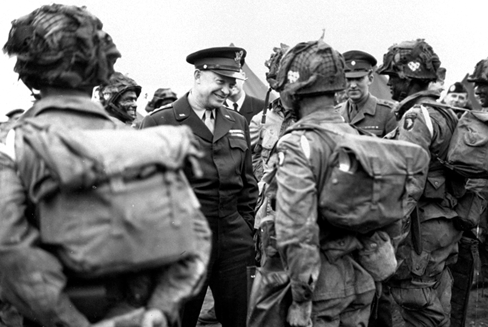 In this June 6, 1944, file photo, provided by the U.S. Army Signal Corps, General Dwight Eisenhower gives the order of the day, "Full Victory — Nothing Else" to paratroopers in England just before they board their planes to participate in the first assault in the invasion of the continent of Europe. (U.S. Army Signal Corps Photo via AP)