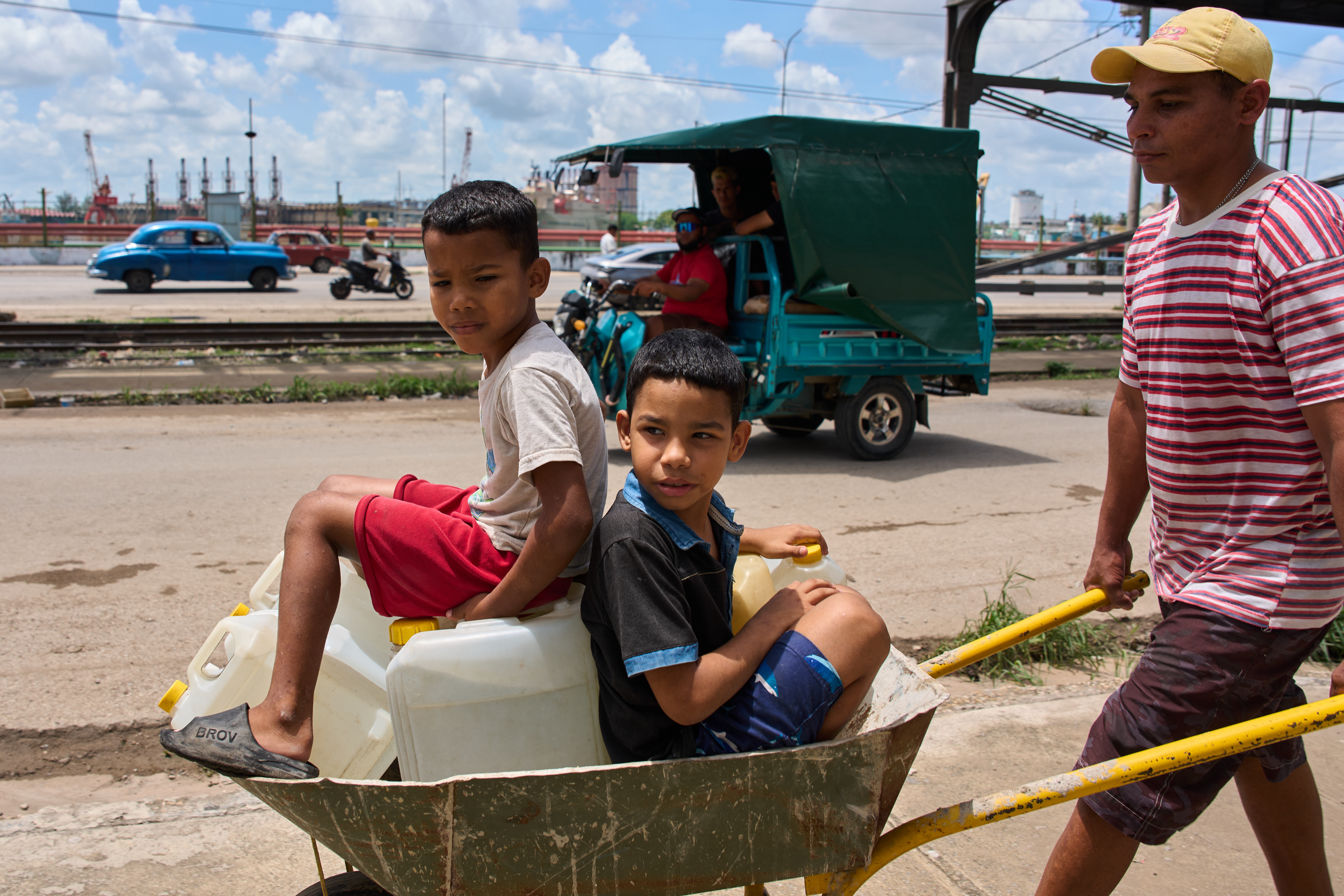 A man transports containers of water with his children in Havana May 28, 2026. (AP/Ramon Espinosa)