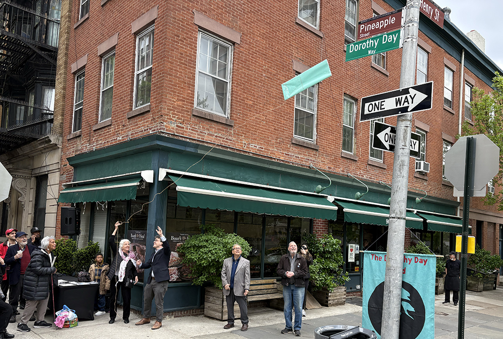 Martha Hennessy, Dorothy Day's granddaughter, and Councilman Lincoln Restler unveil the Dorothy Day Way sign in Brooklyn Heights on May 2. (NCR Photo/Camillo Barone)