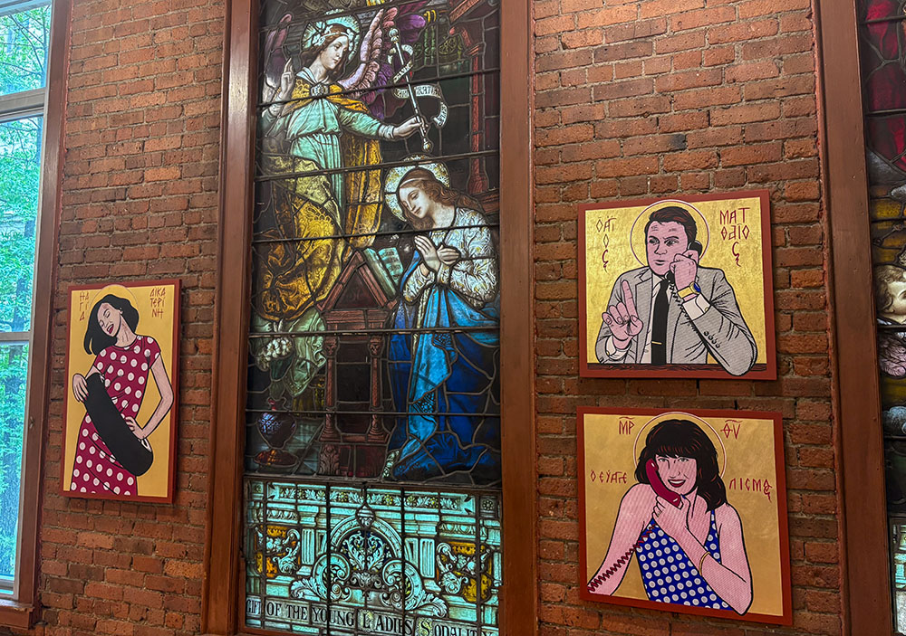 At left, "St. Catherine of Alexandria" and, at right, "The Call of Levi (Mad Man)" and "The Annunciation," artworks displayed at the "Twilight of the Idols" exhibition in St. Mary Chapel at St. Francis Xavier Church in New York in May 2026 (NCR photo/Camillo Barone)