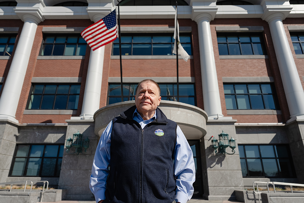 Thomas Koch, mayor of Quincy, Mass., stands in front of the city's new public safety headquarters building where he wants to place two saint statues. (Courtesy of Becket Fund)