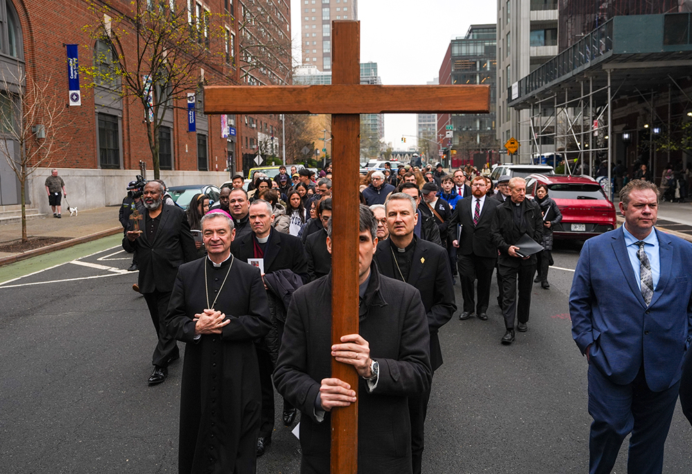 New York Archbishop Ronald Hicks walks with a cross during the "Way of the Cross" over the Brooklyn Bridge on Good Friday, April 3, 2026, in New York. (AP photo/Ryan Murphy)