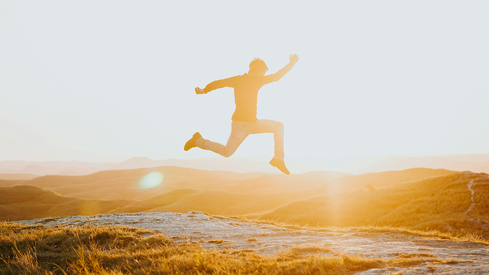 Silhouette of a man leaping with the sun on the horizon (Unsplash/Wahde Stock)