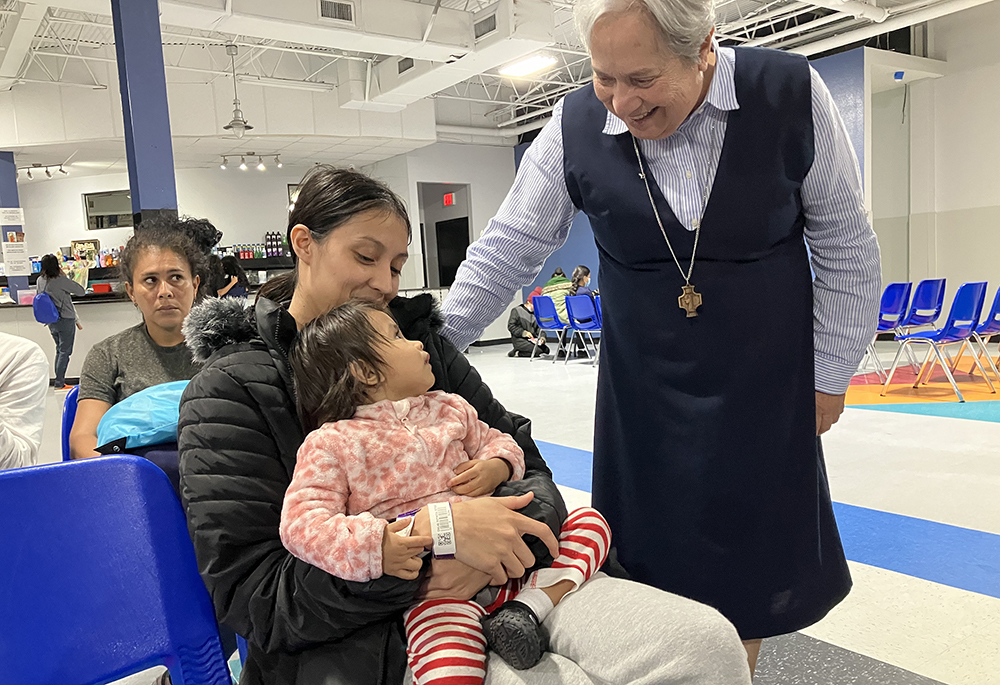 Sr. Norma Pimentel, a Missionary of Jesus, greets Esther Chicas, a recently arrived migrant from El Salvador, and her child, Andrea, at the Humanitarian Respite Center in McAllen, Texas on Nov. 11, 2023. (OSV News/David Agren)