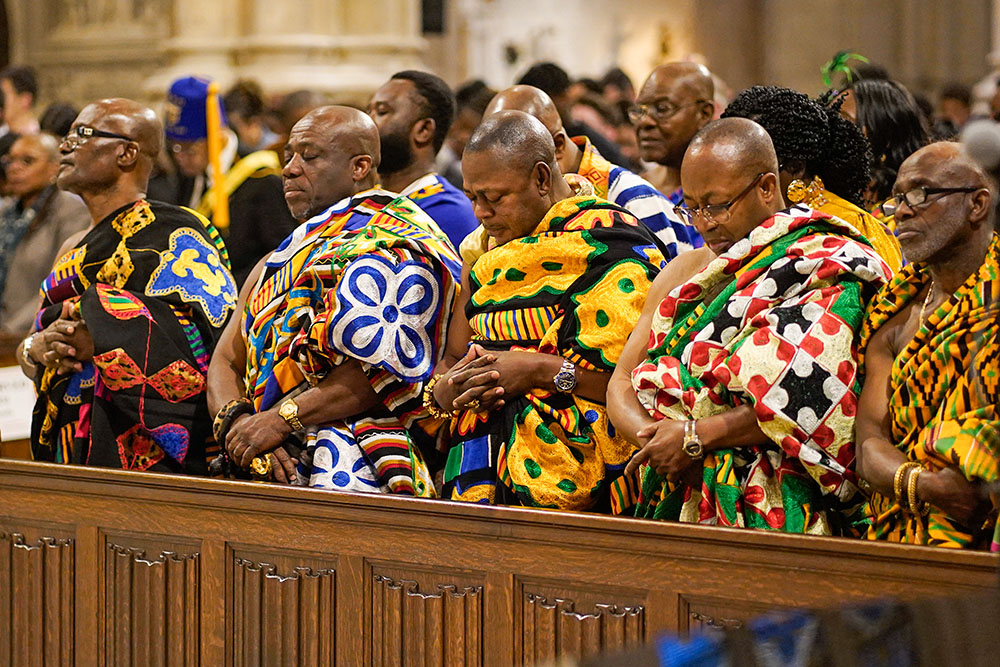 Men wearing ceremonial Ghanaian clothing pray during the New York Archdiocese's annual Black History Month Mass at St. Patrick's Cathedral in New York City Feb. 4, 2024. (OSV News/Gregory A. Shemitz)