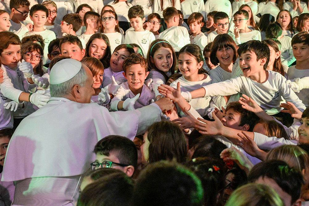 Pope Leo XIV shakes hands with students at the Pontifical Paul VI School in Castel Gandolfo, Italy, after he attended their Christmas concert in the school gym Dec. 16, 2025. (CNS/Vatican Media)
