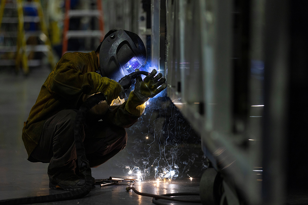 A welder works while building a bus frame at the BYD electric bus factory in Lancaster, Calif., July 1, 2021. (OSV News/Reuters/Mike Blake)