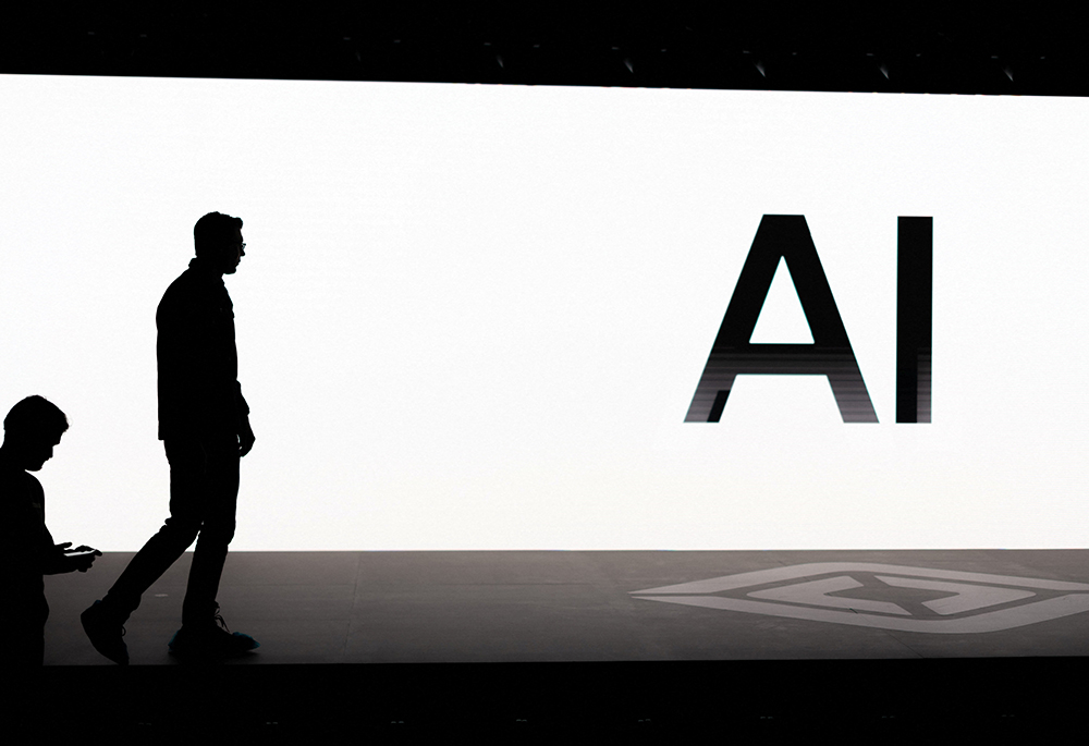 A screen reads "AI" as attendees gather at Rivian's first Autonomy and AI Day in Palo Alto, California, Dec. 11 2025, showing developments in self-driving technology. (OSV News/Reuters/Carlos Barria)