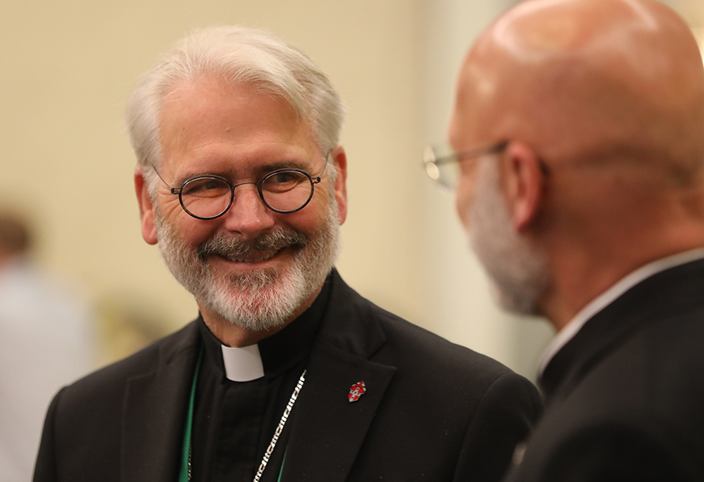 Archbishop Paul S. Coakley of Oklahoma City, now president of the U.S. Conference of Catholic Bishops, and Bishop James S. Wall of Gallup, New Mexico, share a light moment during a break June 16, 2023, at the bishops' spring plenary assembly in Orlando, Florida. The conference's 2026 spring assembly will be held in Orlando June 10-12, with public sessions scheduled for June 10 and 11. (OSV News/Bob Roller)