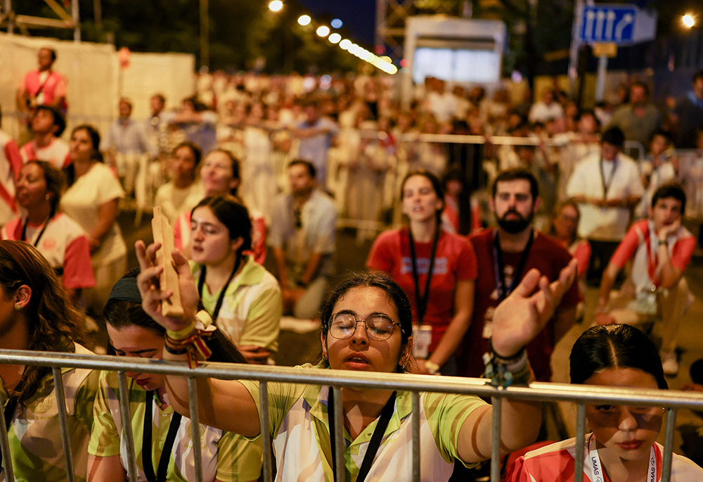 A young person gestures as Pope Leo XIV holds a prayer vigil at Plaza de Lima in Madrid June 6, 2026, during his apostolic journey to Spain. (OSV News/Reuters/Mohammed Salem)