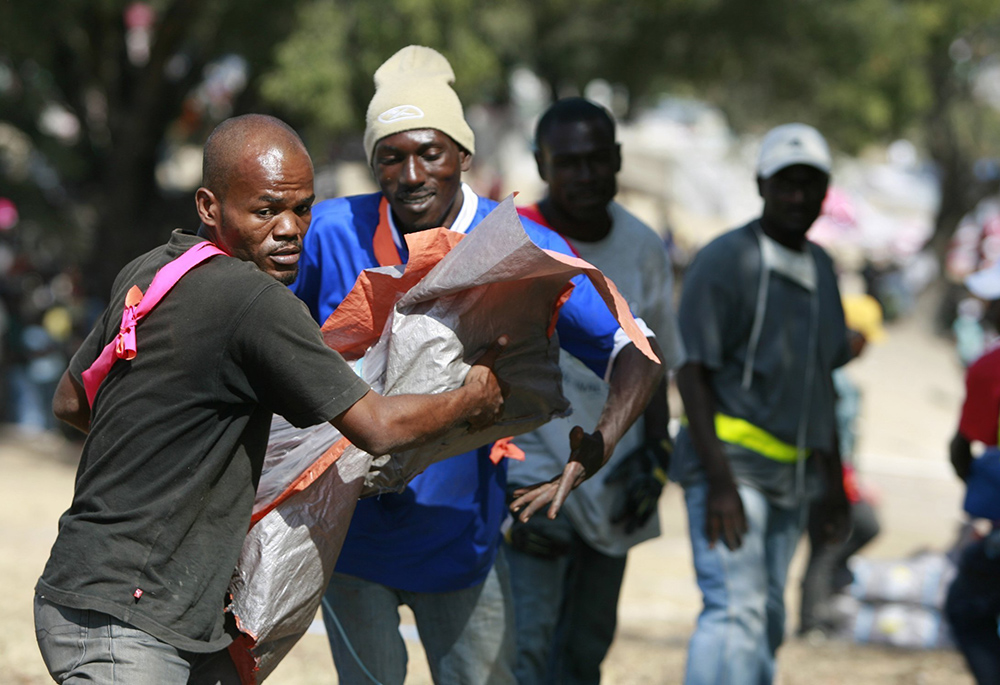 Workers distribute shelter kits assembled by Catholic Relief Services at a camp for survivors of the 2010 earthquake in Port-au-Prince, Haiti. The U.S. Department of State announced June 5, 2026, that a $240 million grant in humanitarian and disaster response assistance — the first of a series of such grants — will be made to CRS, the overseas relief and development arm of the U.S. Catholic Church. (OSV News/Bob Roller)