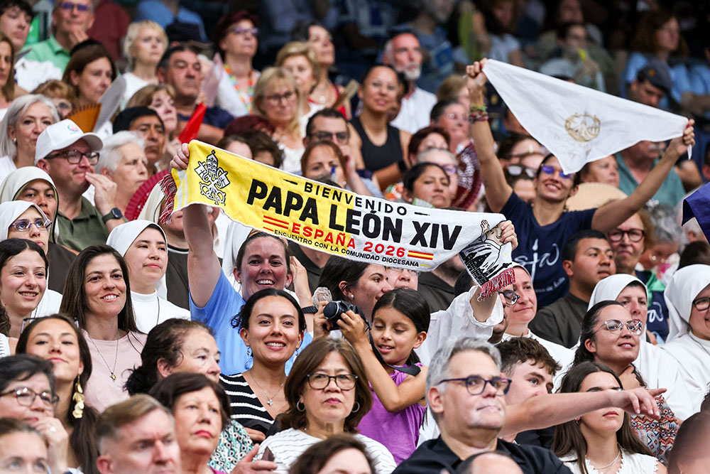 Pilgrims hold a banner as they wait for Pope Leo XIV to arrive for a meeting with the diocesan community at the Santiago Bernabeu Stadium in Madrid June 8, 2026, during his June 6-12 apostolic journey to Spain. (OSV News/Reuters/Yara Nardi)