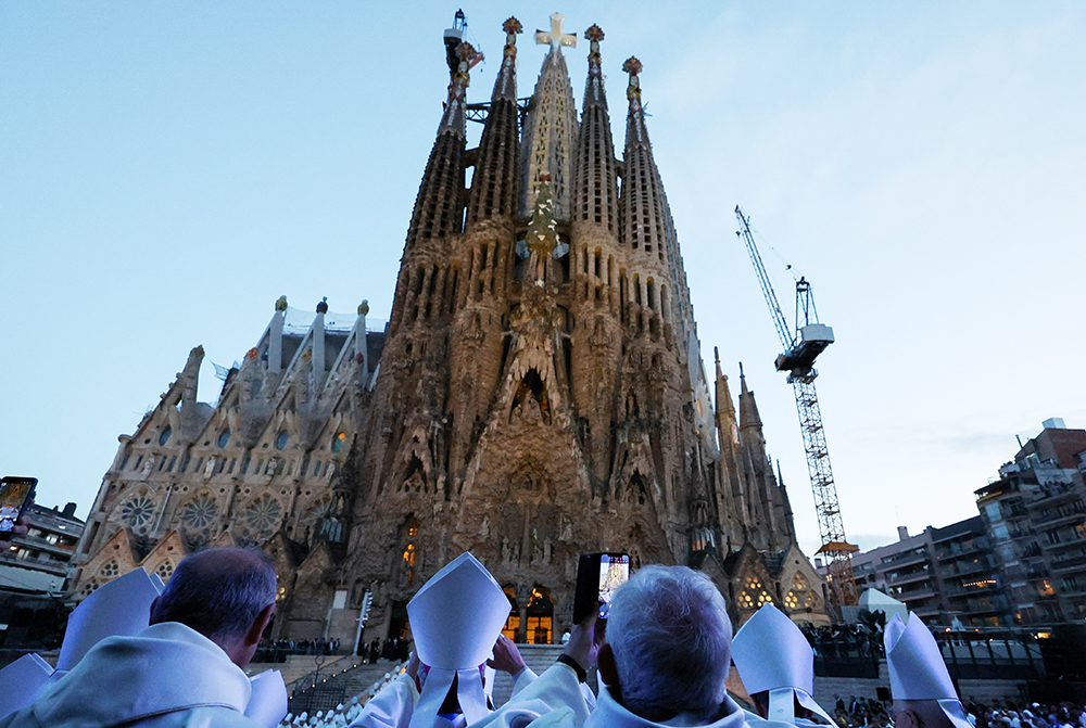Members of the clergy stand outside the Basilica of the Sagrada Familia in Barcelona on the day of the inauguration and blessing of the Tower of Jesus Christ by Pope Leo XIV during his apostolic journey to Spain, June 10, 2026. (OSV News/Reuters/Nacho Doce)