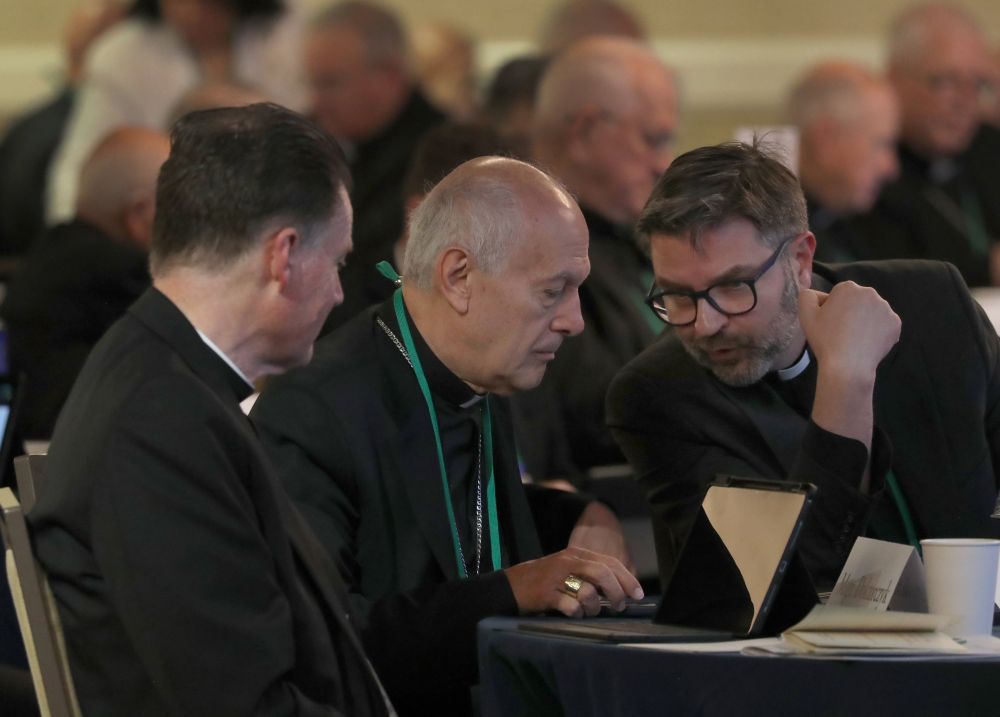 Archbishop Gabriele Caccia, the Vatican's new apostolic nuncio to the United States, chats with another prelate during a June 11, 2026, session of the annual spring meeting of the U.S. Conference of Catholic Bishops in Orlando, Fla. (OSV News/Bob Roller)