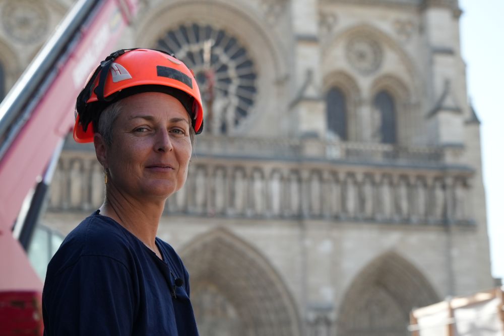 Camille Colonna, archaeologist in charge of operations, wearing a safety helmet, poses in front of Notre Dame Cathedral during excavations in Paris June 1, 2026. (AP/Nicolas Garriga)